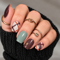 Cider & Sage nail wraps on long squoval nails, featuring chocolate brown, sage green, cream plaid and gold foil accents.