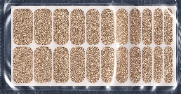Package of Deluxe Size nail wraps with 22 glittery gold nail strips in a silver package. 