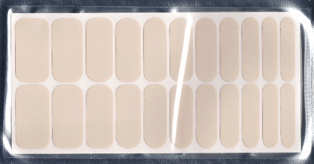 This image showcases 22 seashell white nail polish wraps, neatly arranged on a rectangular sheet within a protective sleeve. The wraps, varying in size, are a pale, creamy off-white, presented in a clean, straightforward product shot that highlights their neutral color and practical design.