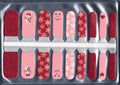 Set of children's red and pink nail stickers with snowflake patterns.