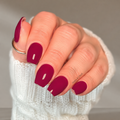 Dark crimson red nail wraps on almond-shaped nails with glossy burgundy finish