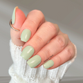 Close-up of pastel green nail wraps on short, square-shaped nails with a glossy finish. A soft, muted green manicure that’s easy to apply and perfect for everyday wear.