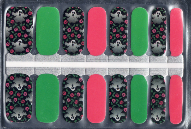 Nail art stickers with skull and flower design on a clear sheet.