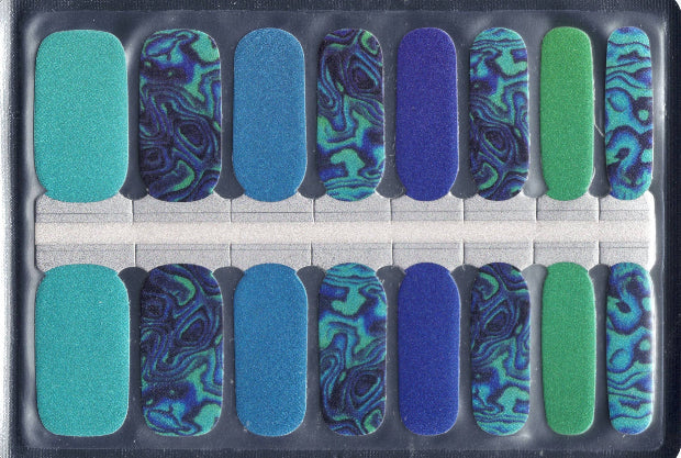 Set of 16 blue and green nail wraps with a decorative pattern in a clear plastic package.