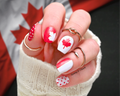 Hand with red and white Canadian flag nail wraps