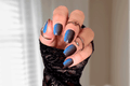 Hand with blue and black ombre nail polish wraps