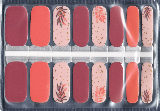 Set of nail art stickers in various shades of red and pink with floral designs on a clear backing.