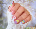 Nail art stickers with bunny and Easter egg designs on a blurred natural background
