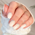 Nude glitter gradient nail wraps with silver sparkle on short square nails, cozy sweater background