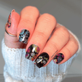 Black Opal nail wraps shown on nails with a dark iridescent glitter design and jewel-toned glitter.