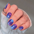 blue and purple nail wraps on a hand