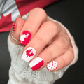 Canada Day maple leaf nail wraps in red and white with glossy finish and polka dot accent nail