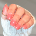 Coral Moon sheer pink nail wraps with a soft coral manicure and visible natural lunula at the cuticle.