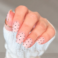Dotty About You pink polka dot nail wraps by Hanny & Chuck, shown on short square nails