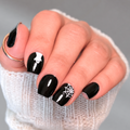 Fright & Flight black nail wraps with white ghost and spiderweb designs on short square nails