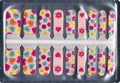 Groovy kids nail wraps with colourful smiley faces, flowers and hearts on a pink background