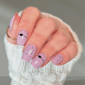 Mauve nail wraps with black heart and line design on short square nails