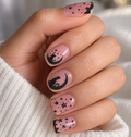 Lucky Luna nail wraps on short square nails, with black cat and crescent moon accent nails and scattered black stars over a sheer glitter base