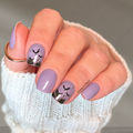 Midnight Bite lavender nail wraps with black bat silhouettes on short square nails