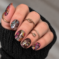 opal nail wraps with glitter on a hand with dark sleeve
