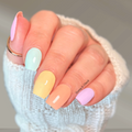 Pastel Daydream pastel rainbow nail wraps shown on nails with pink, mint, yellow, peach, and lavender shades.