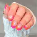 Pink and orange abstract French tip nail wraps on natural nails with a soft glossy finish