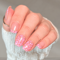 Pink Prowl pink leopard print nail wraps on short natural nails with gold accent details
