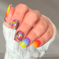 Rainbow nail wraps with colourful feather-inspired patterns and bright neon gradient nails on a hand wearing a cozy white sweater.