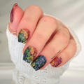 Hand with rainbow clover glitter nail wraps manicure