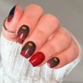 Scarlet & Spooky nail wraps on manicured nails showing burgundy spooky details and bright red glitter strips in alternating pattern