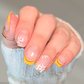 Sunshine Daisy yellow and orange daisy French tip nail wraps on natural nails