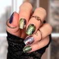 Wide fit nail wraps with mixed colour glitter designs on short nails, including green, purple, and silver sparkle patterns.