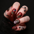 Hand with red and green nail polish strips on a black background