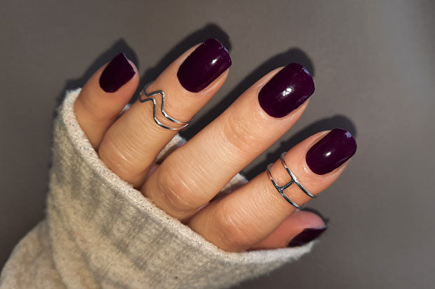 Nails showing very dark purple nail wraps