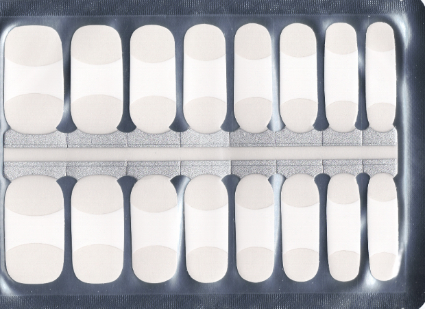 A grid of sixteen nail strips, arranged in two rows, displays a consistent design: a white, half-moon shape at the top of each clear strip, mimicking a French manicure tip. The rest of the strip appears clear, indicating its adhesive nature for easy application. The strips are contained within a clear package.