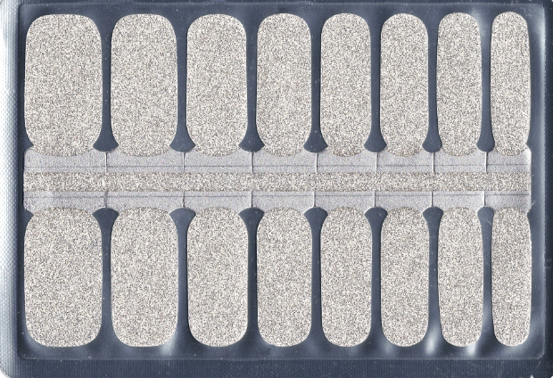 A package of 16 white glitter nail polish strips.